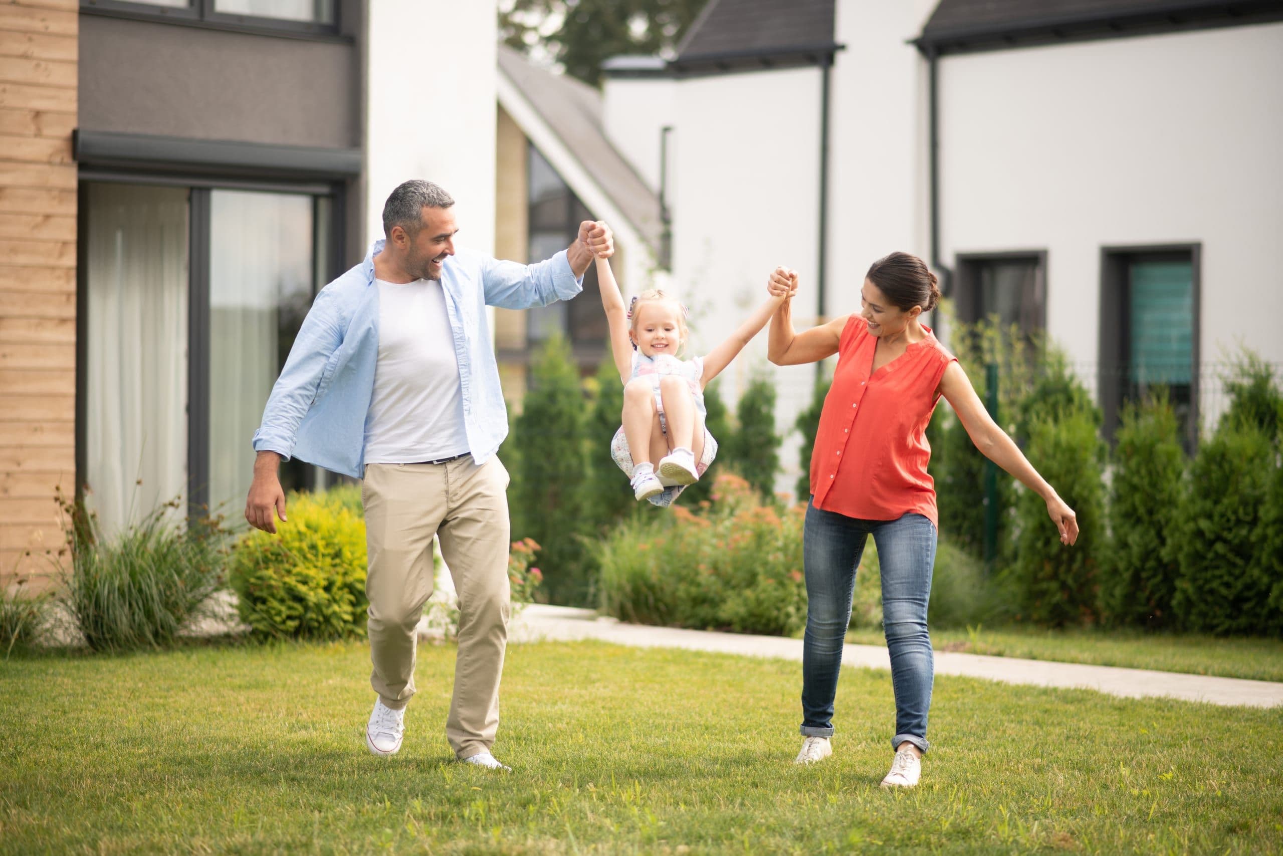 A family walking together in the garden of their home